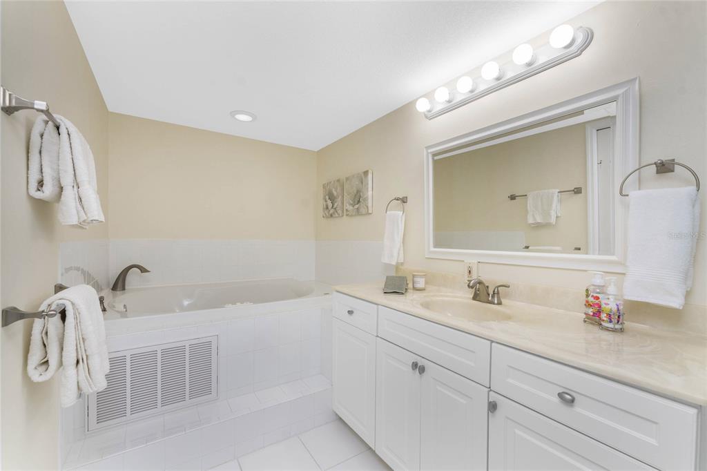3021 Matecumbe Key Road, Unit 4 Punta Gorda, FL 33955 - Photo 26 of 42 a bathroom with a double vanity sink mirror and bathtub