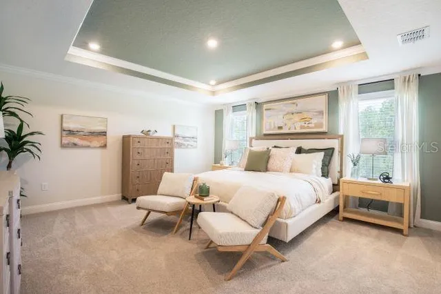 a bedroom with a bed and a painting on the wall