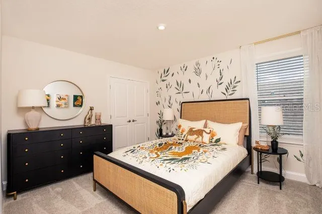 a bedroom with a bed and a dresser