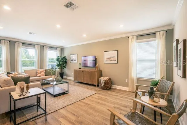 a living room with furniture and a large window