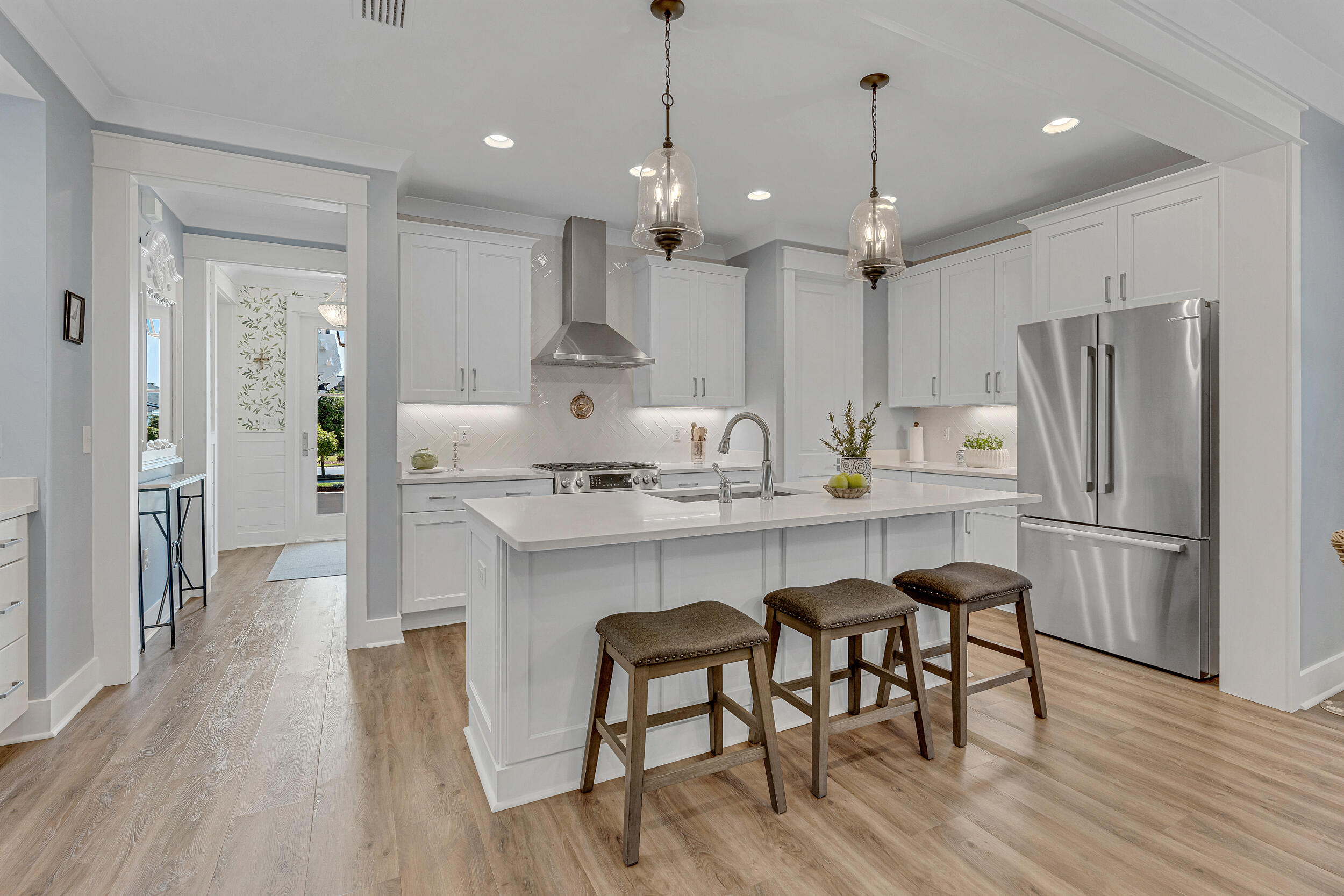 137 Sidecamp Road Watersound, FL 32461 - Photo 7 of 63 a kitchen with stainless steel appliances a dining table chairs refrigerator and microwave