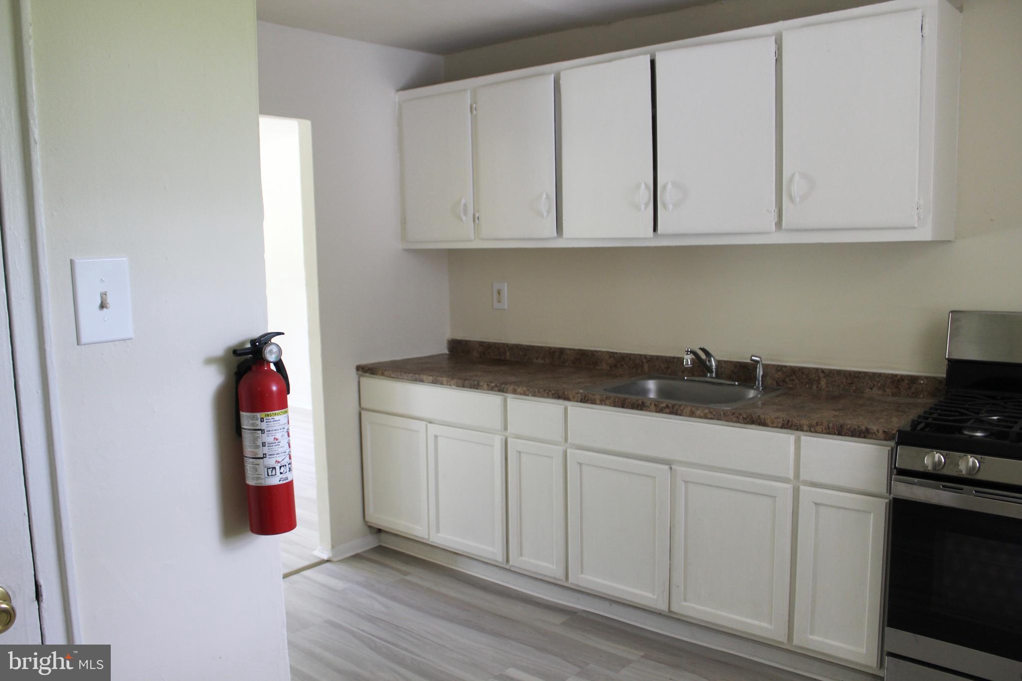 199 Kinsley Road Pemberton, NJ 08068 - Photo 3 of 7 a kitchen with white cabinets and sink