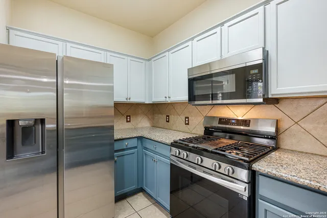 a kitchen with cabinets and steel stainless steel appliances