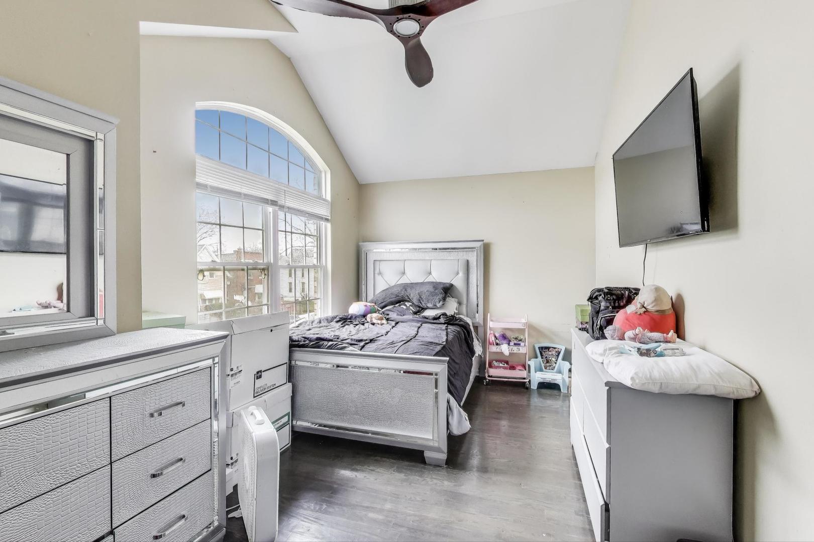 8618 South Morgan Street Chicago, IL 60620 - Photo 13 of 27 a bedroom with furniture and a flat screen tv