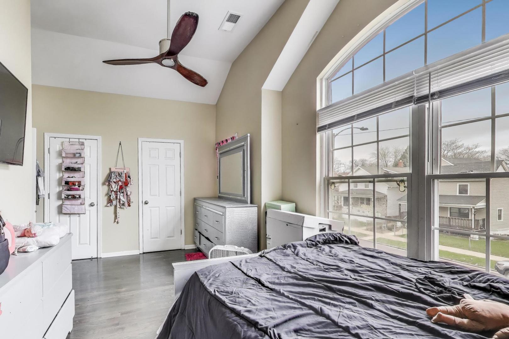 8618 South Morgan Street Chicago, IL 60620 - Photo 14 of 27 a bedroom with a bed and a large window with the outer view