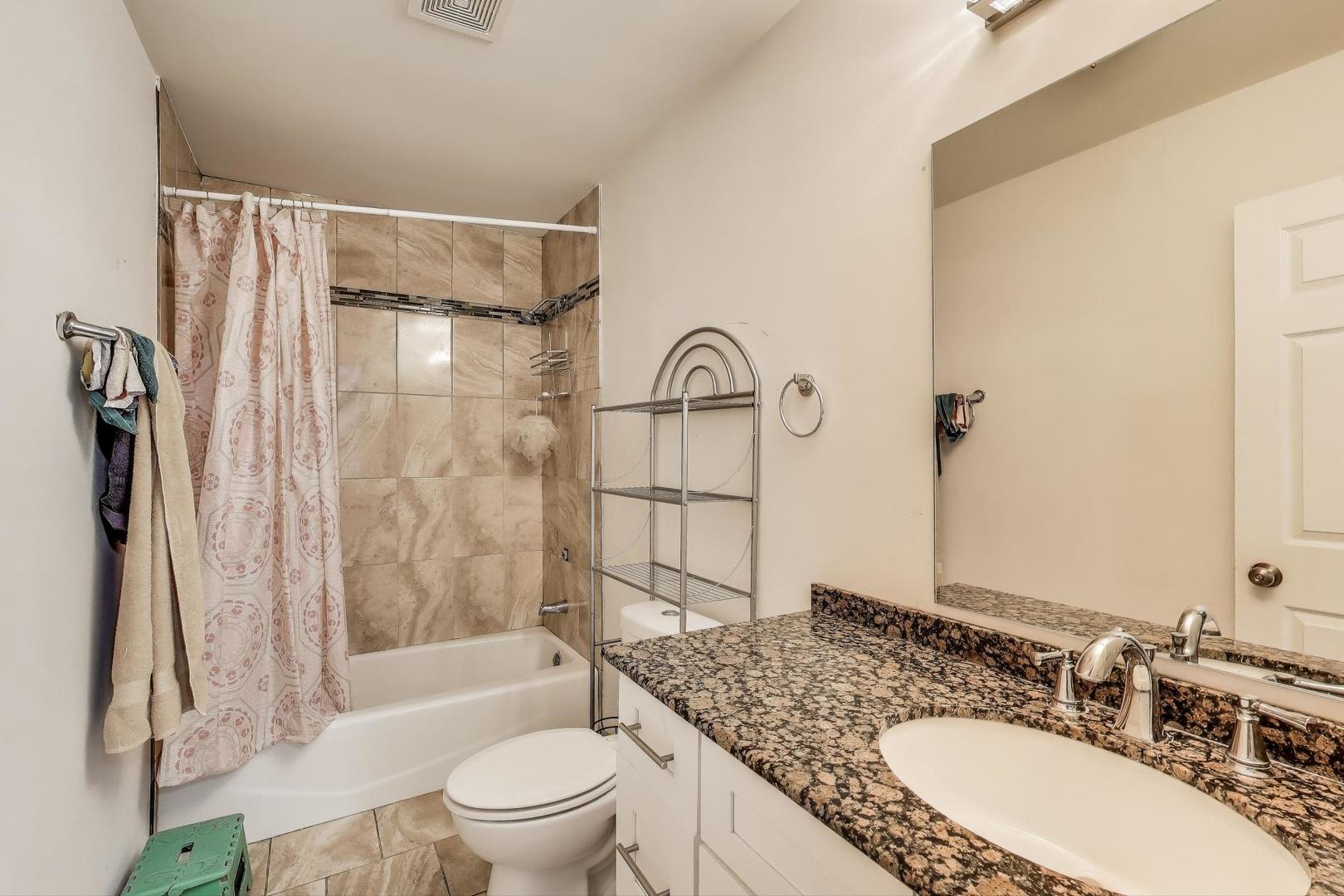 8618 South Morgan Street Chicago, IL 60620 - Photo 17 of 27 a bathroom with a granite countertop sink toilet and shower