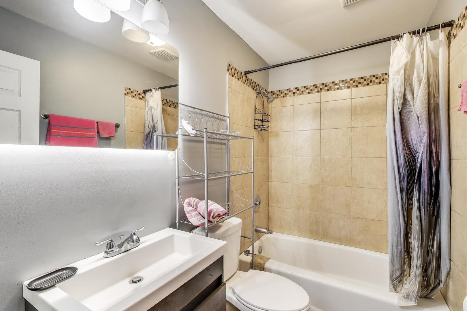 8618 South Morgan Street Chicago, IL 60620 - Photo 20 of 27 a bathroom with a sink and a mirror