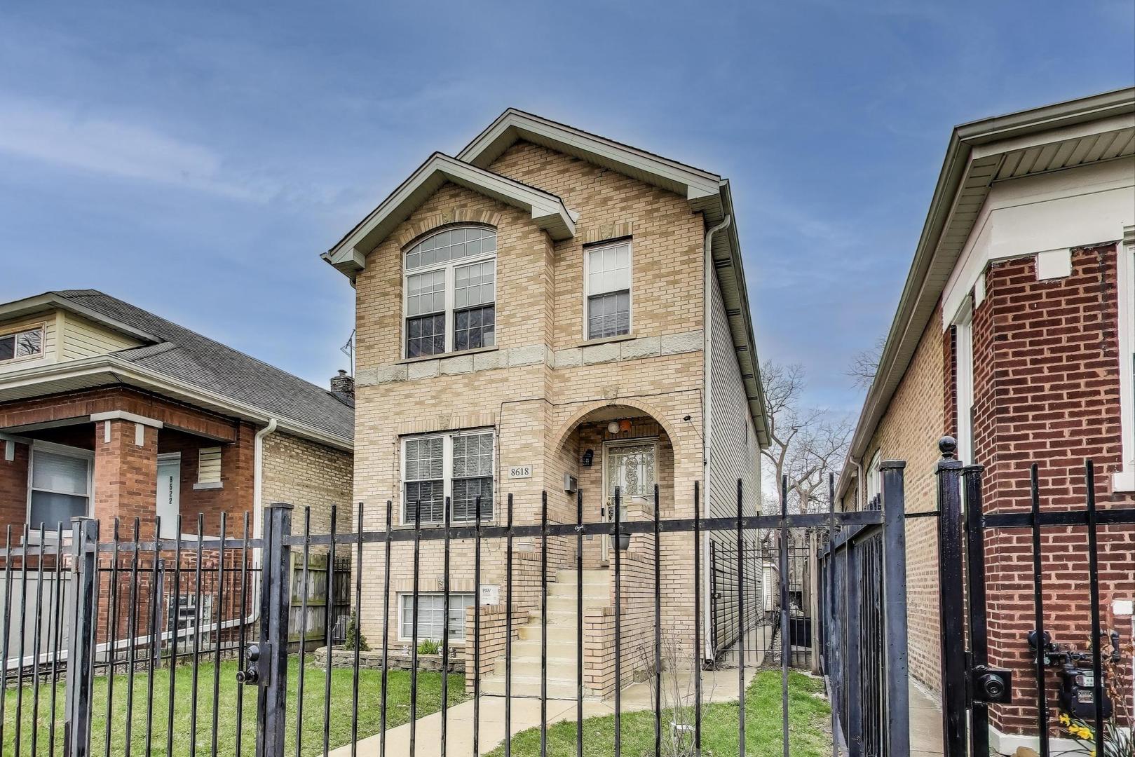 8618 South Morgan Street Chicago, IL 60620 - Photo 2 of 27 a front view of a house with iron fence