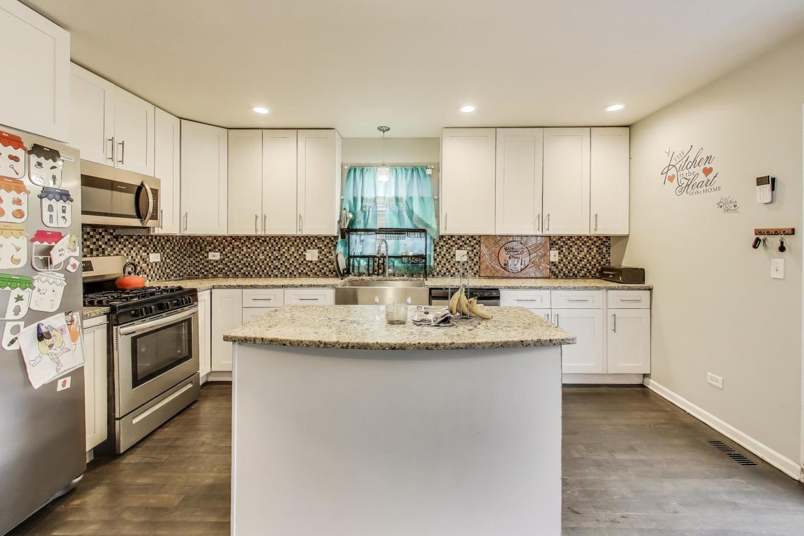 8618 South Morgan Street Chicago, IL 60620 - Photo 7 of 27 a kitchen with stainless steel appliances granite countertop a sink stove and refrigerator