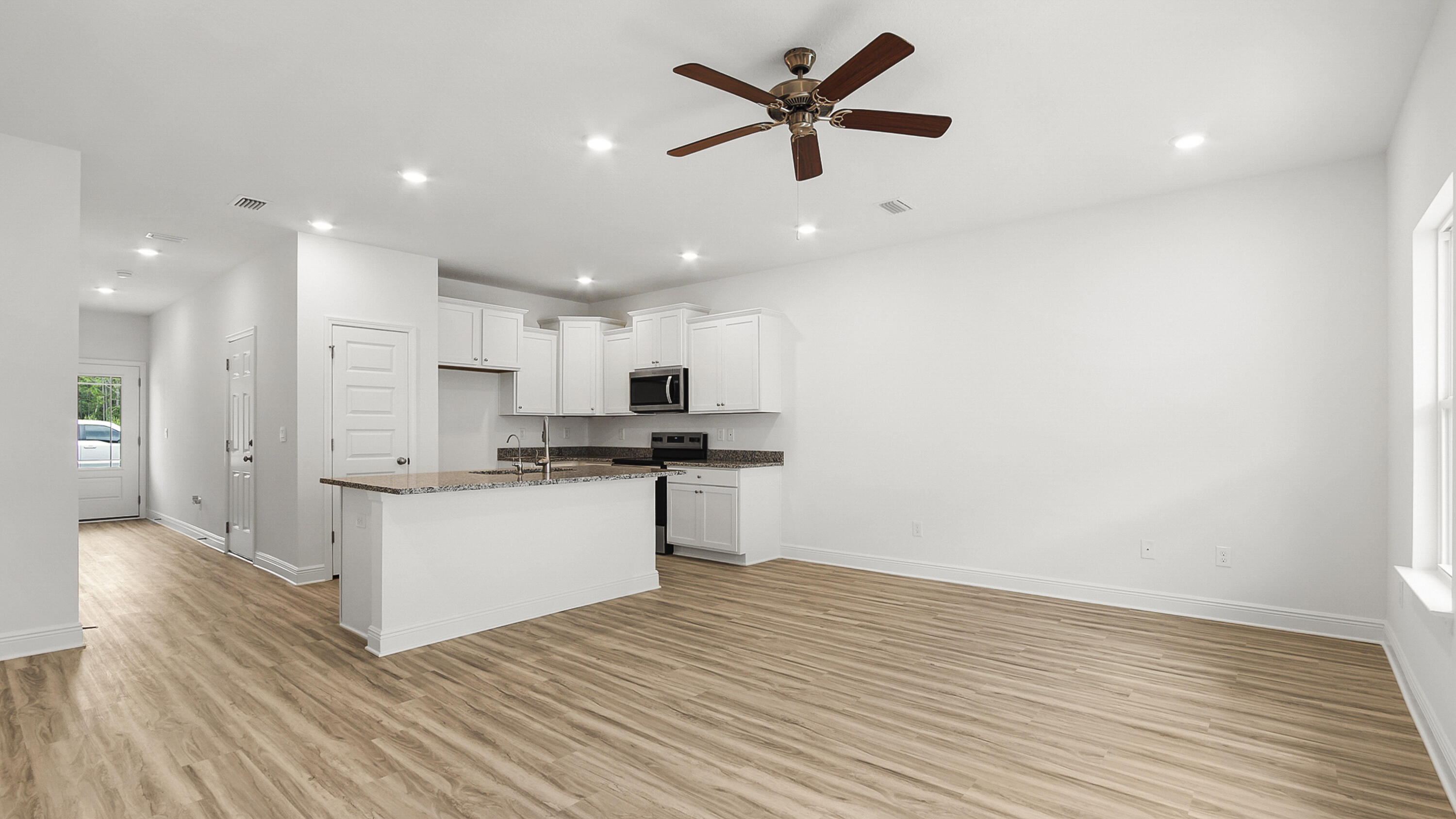 51 Phoenix Street Santa Rosa Beach, FL 32459 - Photo 13 of 34 a kitchen with a refrigerator and white cabinets
