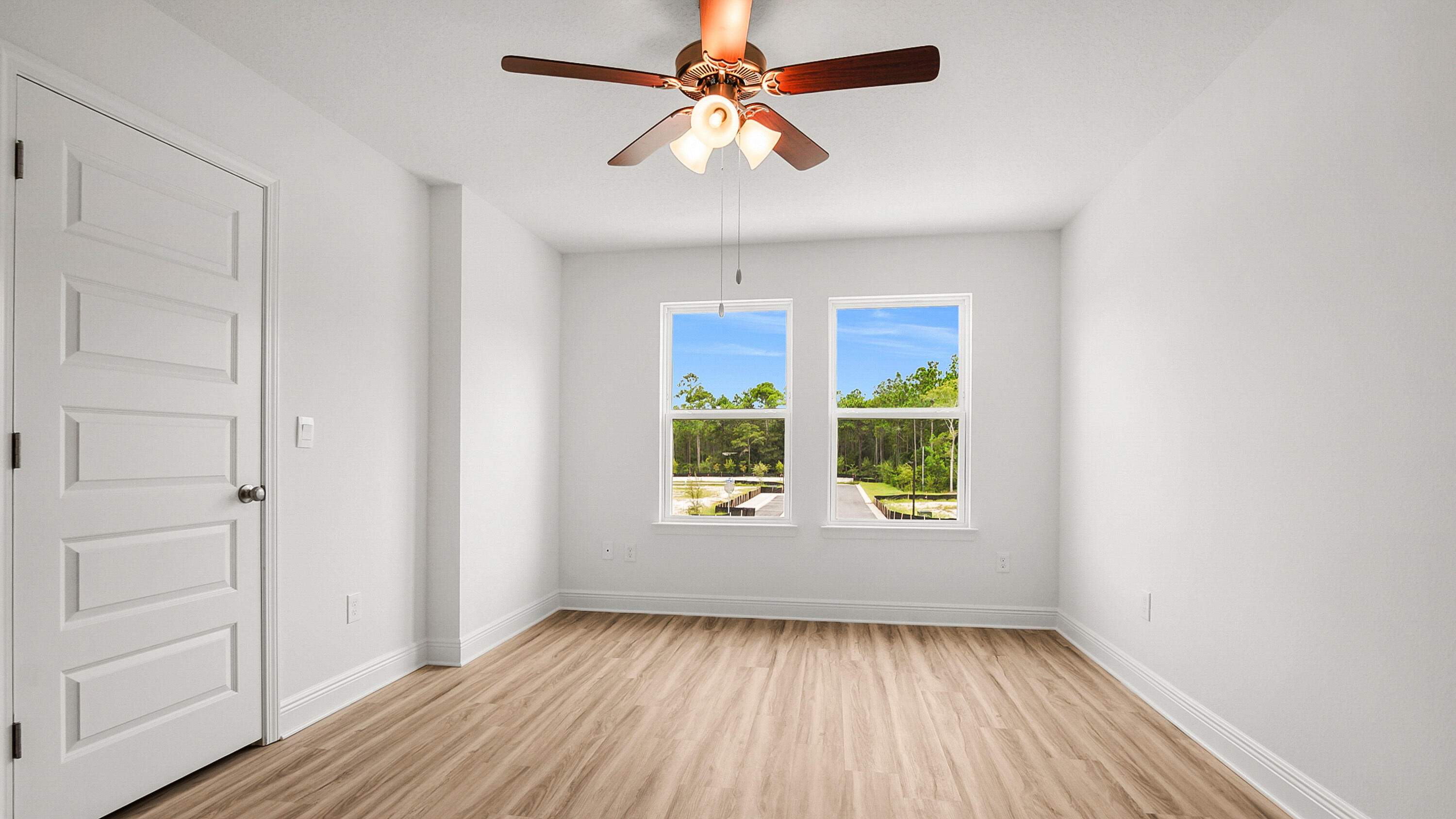 51 Phoenix Street Santa Rosa Beach, FL 32459 - Photo 18 of 34 a view of an empty room with window and wooden floor