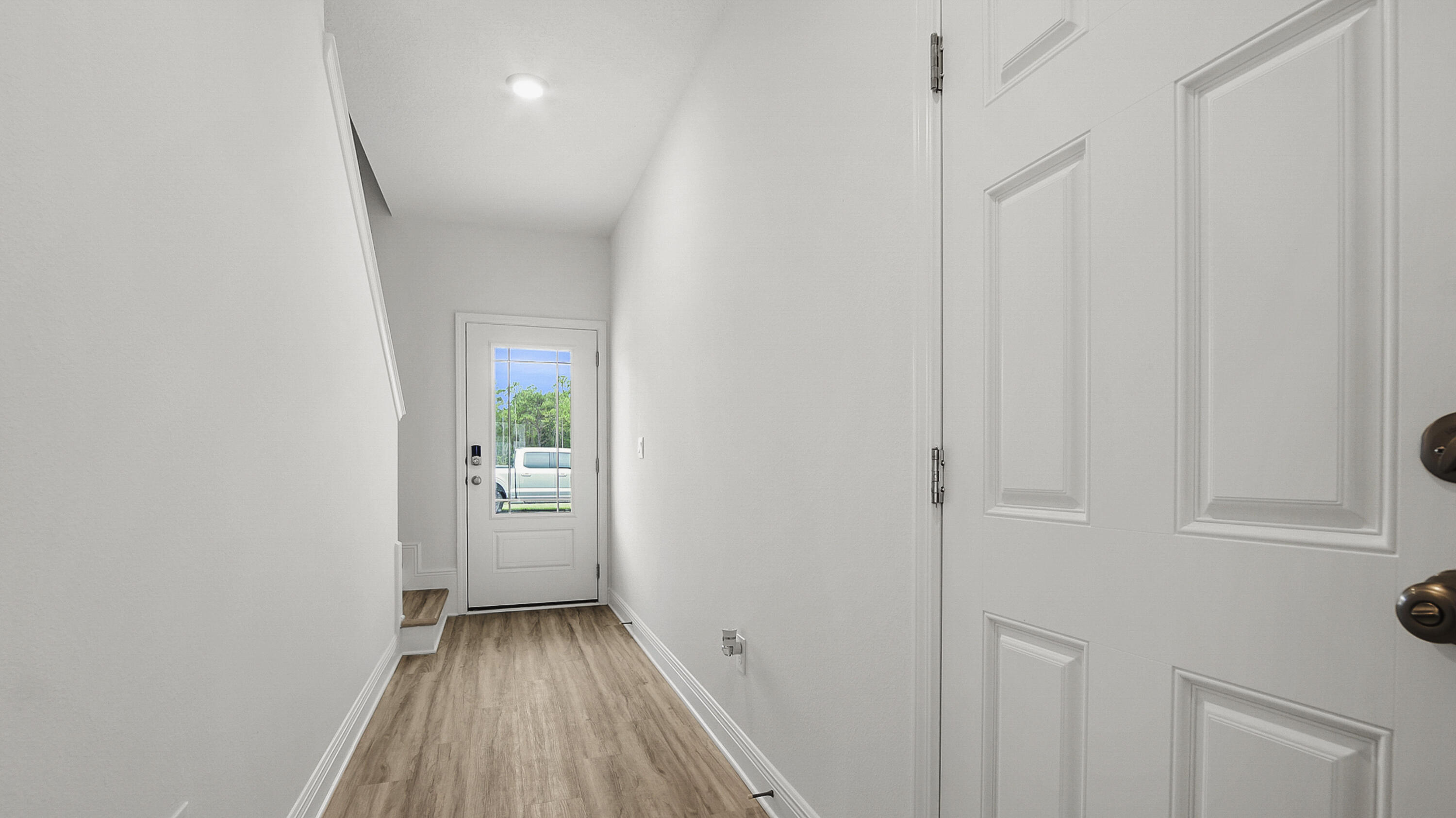 51 Phoenix Street Santa Rosa Beach, FL 32459 - Photo 4 of 34 a view of an empty room with wooden floor and a window