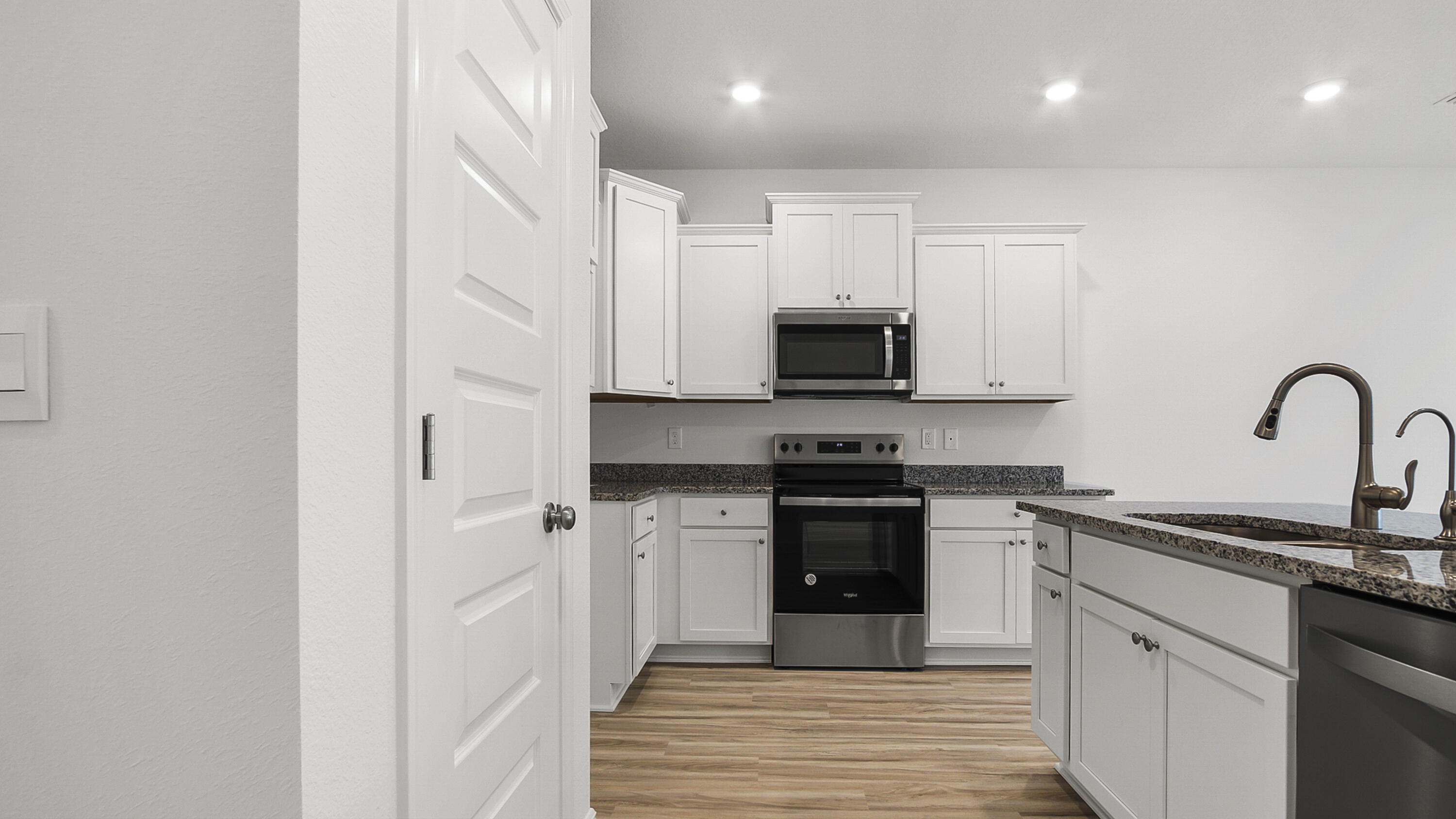 51 Phoenix Street Santa Rosa Beach, FL 32459 - Photo 7 of 34 a kitchen with stainless steel appliances granite countertop a stove top oven a sink and dishwasher