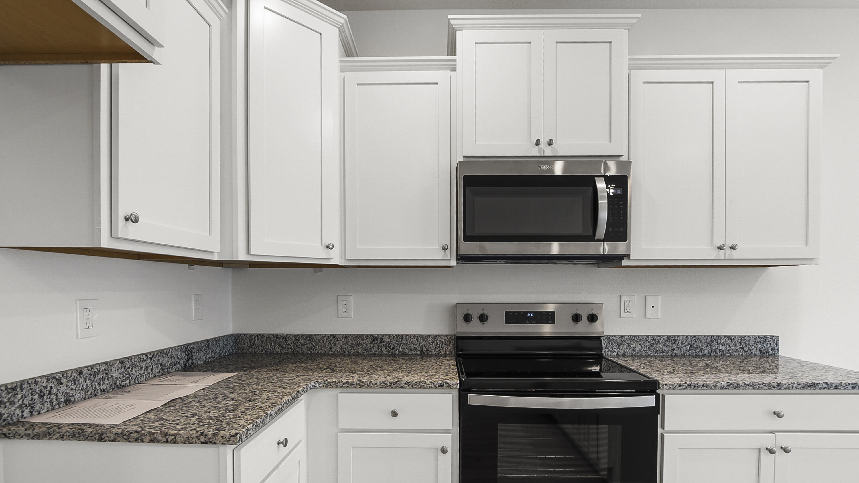 51 Phoenix Street Santa Rosa Beach, FL 32459 - Photo 8 of 34 a kitchen with granite countertop white cabinets and stainless steel appliances