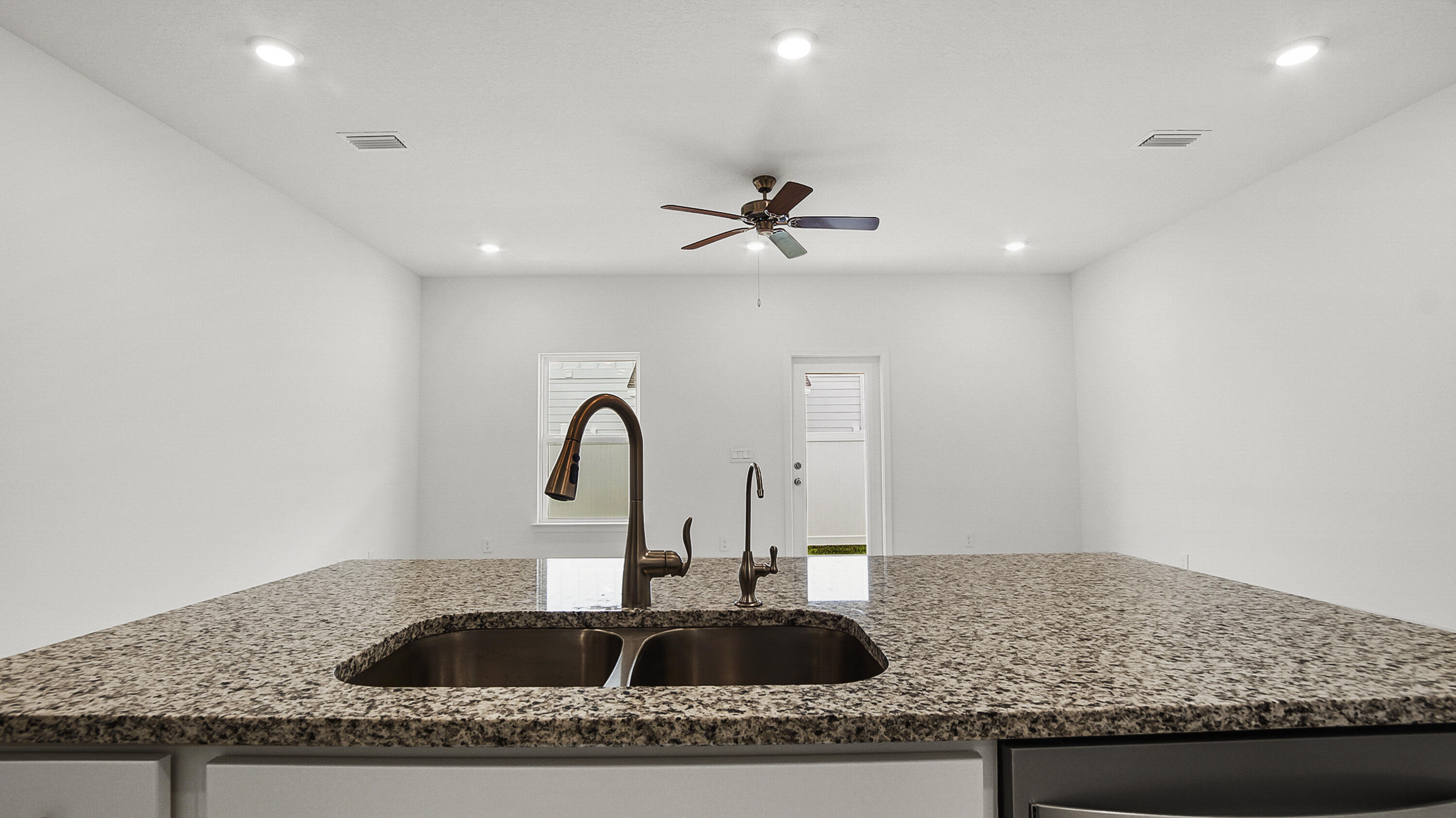 51 Phoenix Street Santa Rosa Beach, FL 32459 - Photo 10 of 34 a kitchen with granite countertop a sink a counter and cabinets