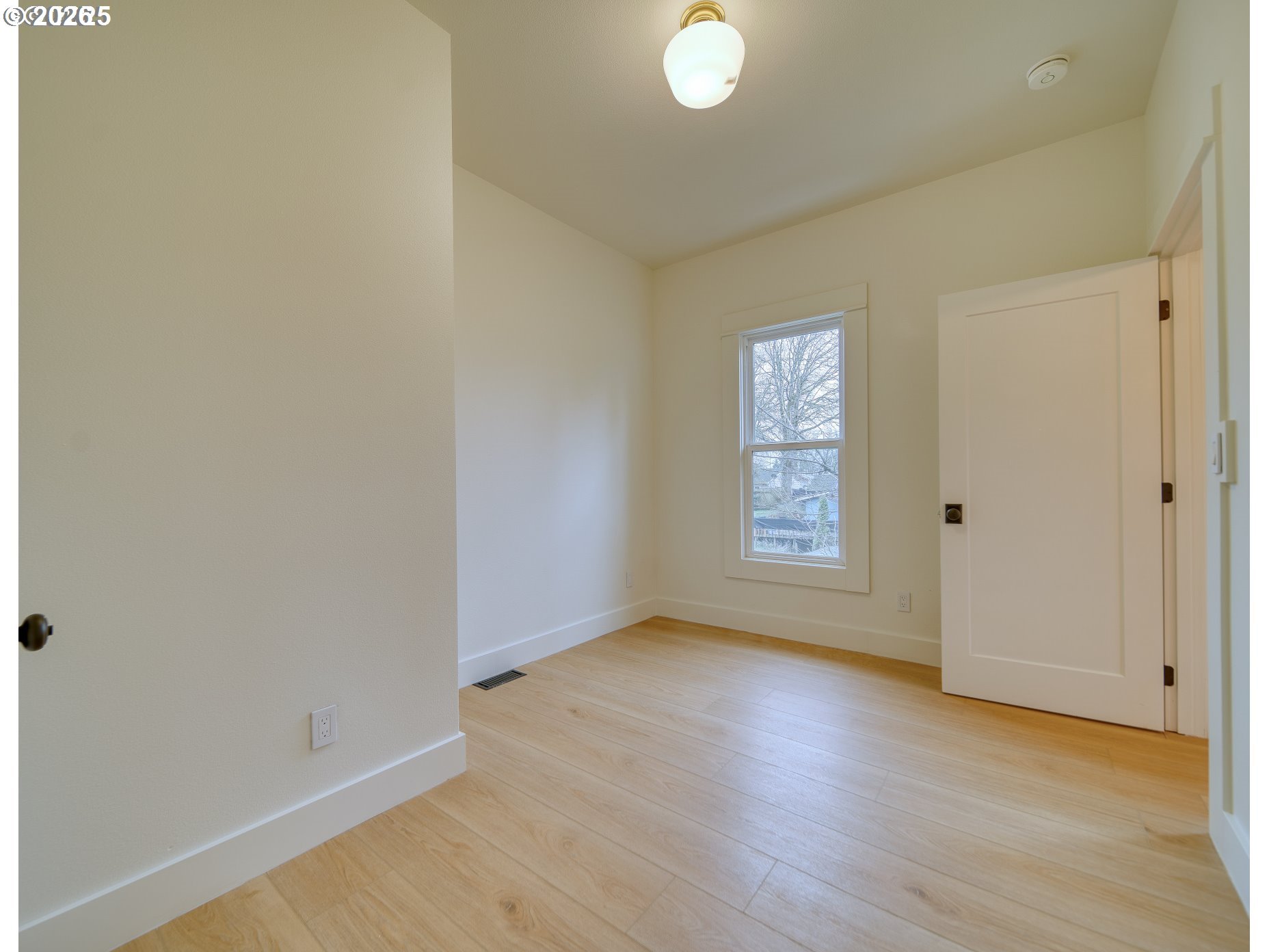 296 North 4th Street St. Helens, OR 97051 - Photo 4 of 17 a view of an empty room with wooden floor and a window