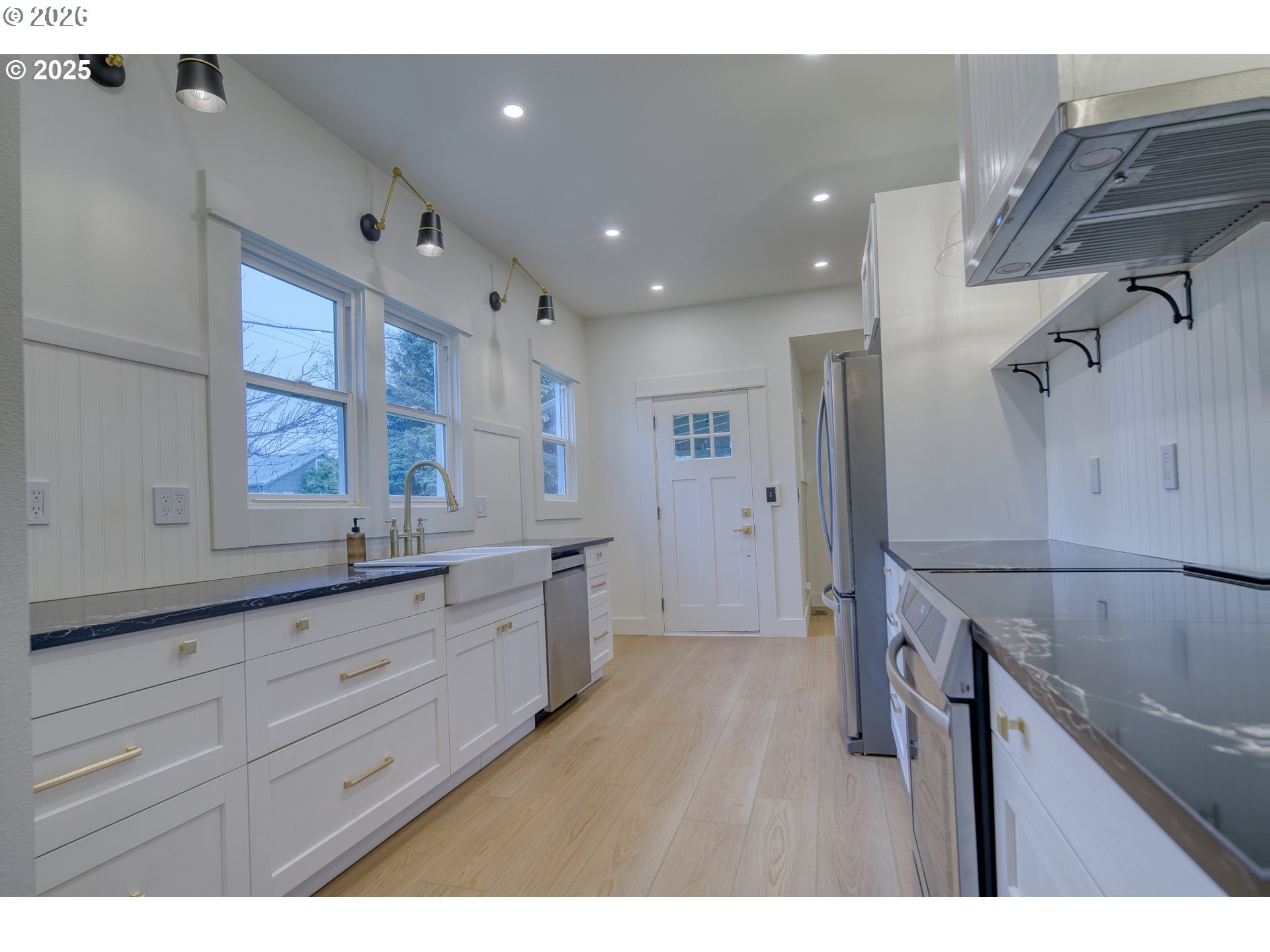 296 North 4th Street St. Helens, OR 97051 - Photo 5 of 17 a kitchen with granite countertop white cabinets and white appliances