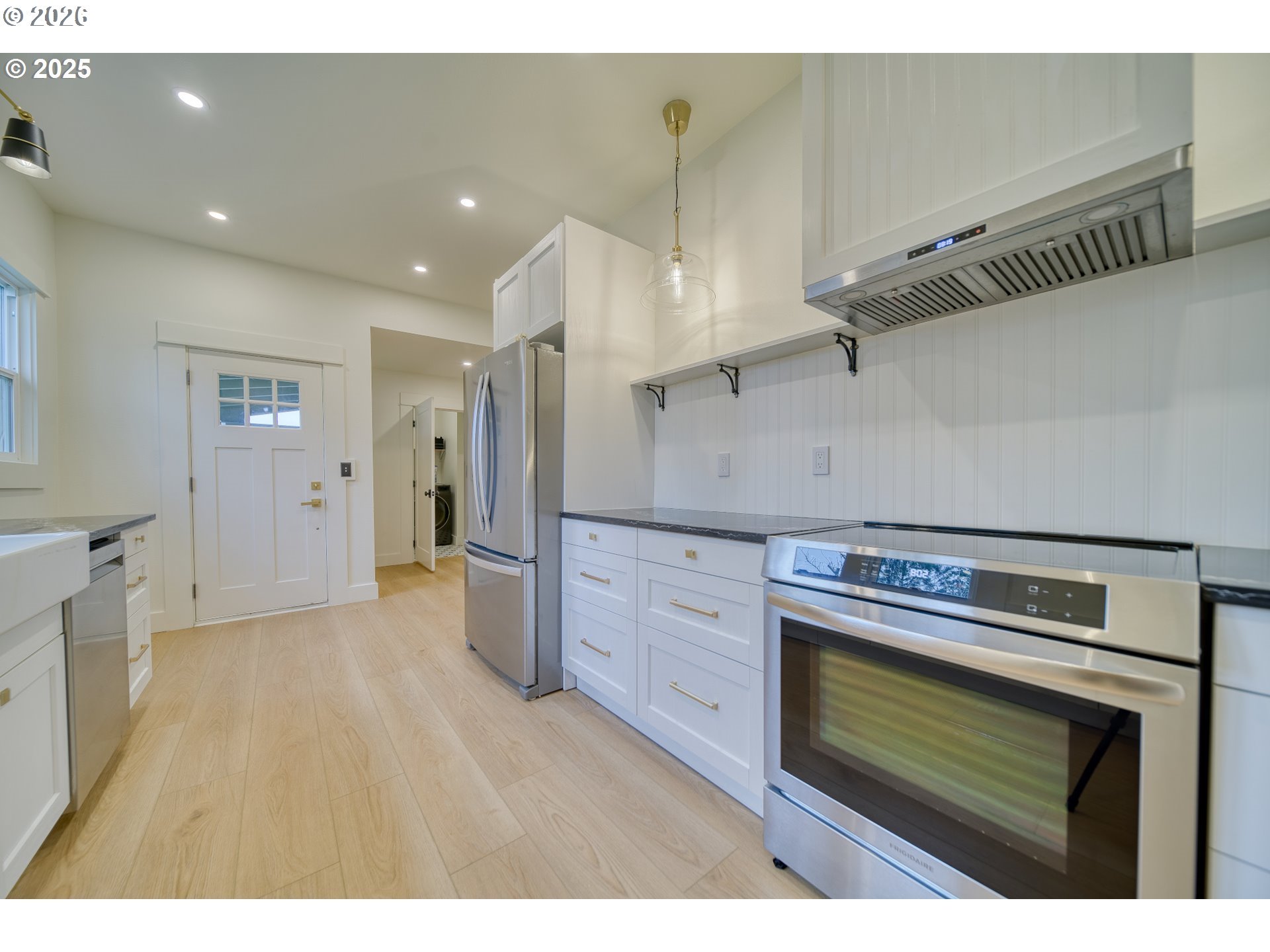 296 North 4th Street St. Helens, OR 97051 - Photo 6 of 17 a kitchen with cabinets and wooden floor
