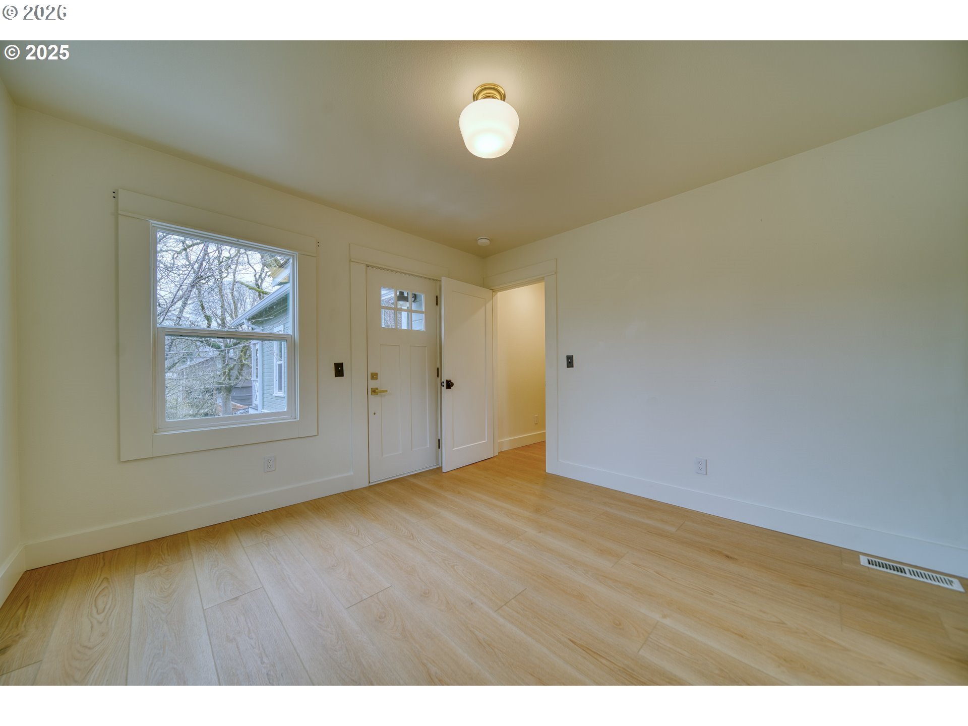 296 North 4th Street St. Helens, OR 97051 - Photo 9 of 17 a view of an empty room with window and wooden floor