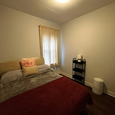 a bedroom with a bed and a potted plant