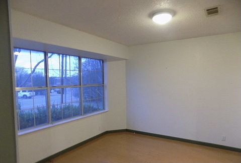 509 Meadowbrook Drive Georgetown, TX 78628 - Photo 14 of 17 A generously proportioned window illuminates this versatile living space, offering ample natural light.