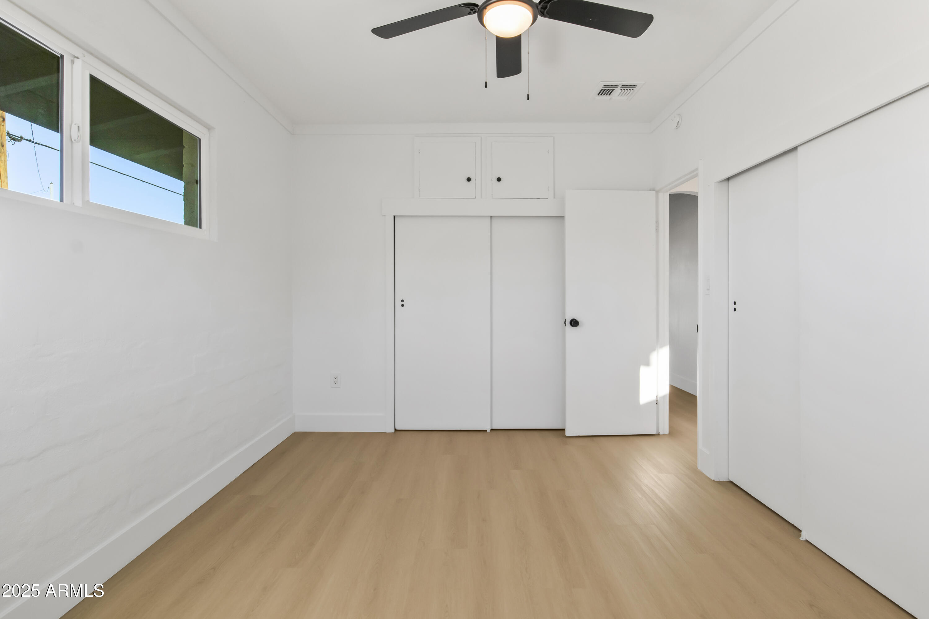 2621 North 14th Street Phoenix, AZ 85006 - Photo 15 of 36 a view of room with hardwood floor and ceiling fan