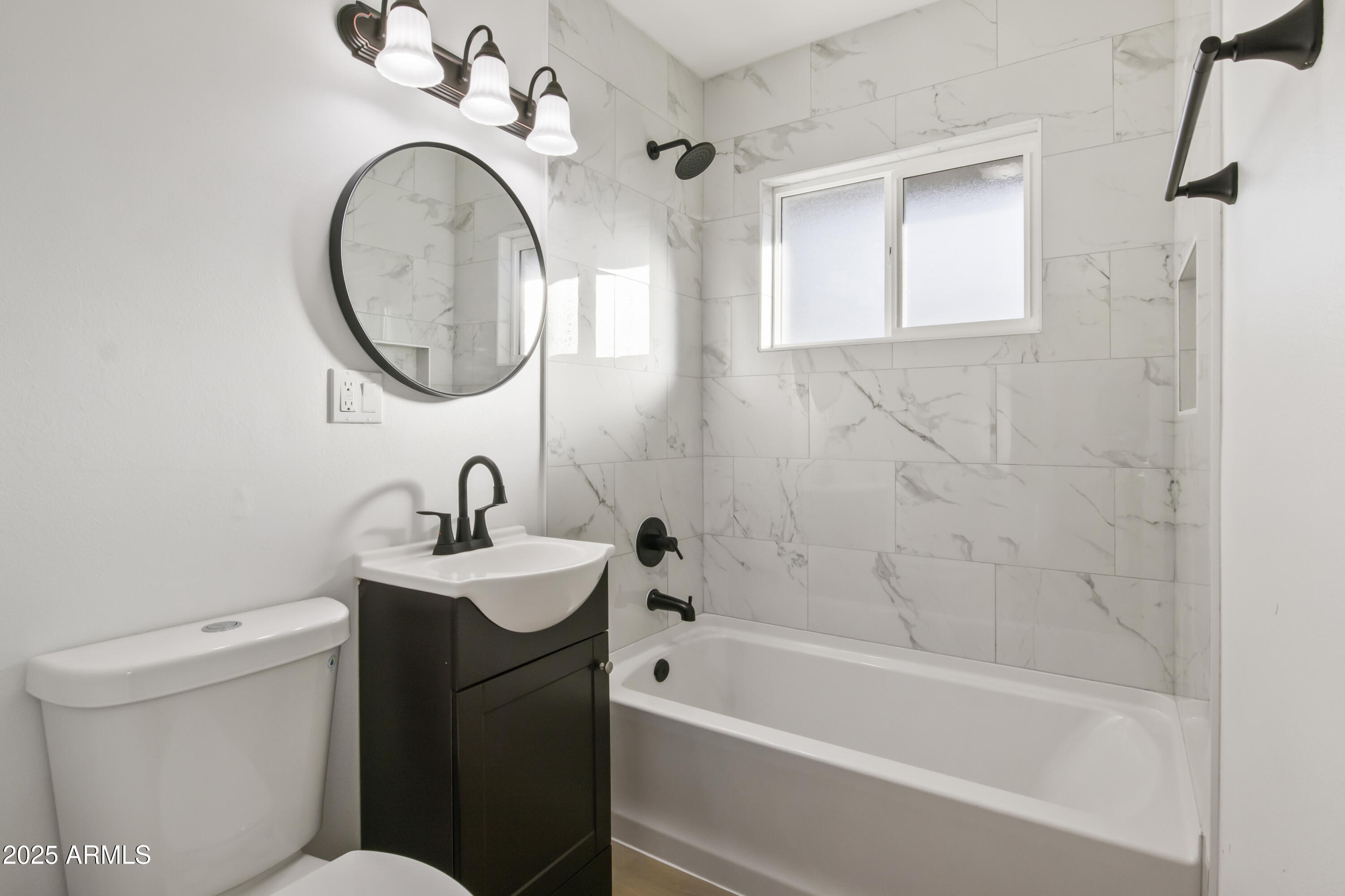 2621 North 14th Street Phoenix, AZ 85006 - Photo 16 of 36 a bathroom with a sink a toilet and a mirror