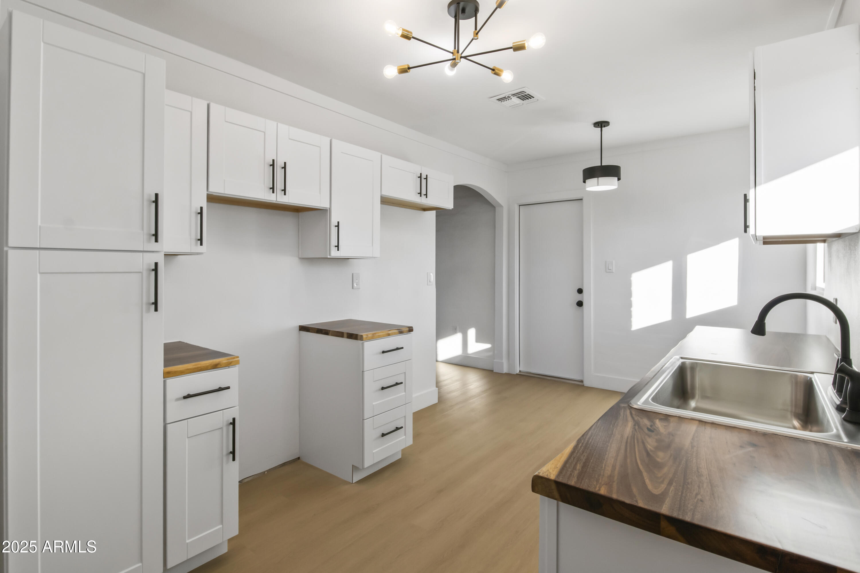 2621 North 14th Street Phoenix, AZ 85006 - Photo 24 of 36 a kitchen with stainless steel appliances granite countertop a sink stove and refrigerator