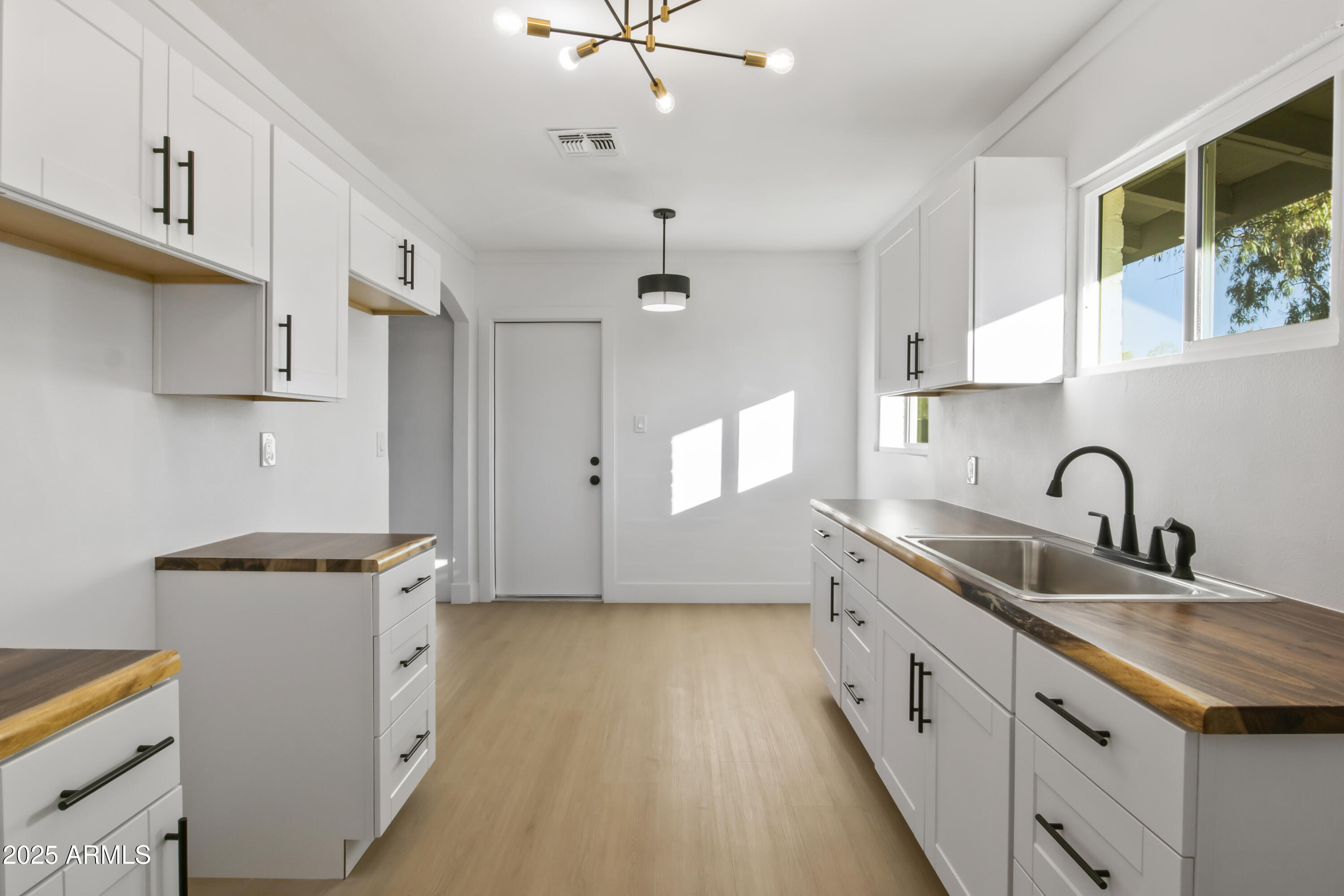 2621 North 14th Street Phoenix, AZ 85006 - Photo 25 of 36 a kitchen with granite countertop a sink a counter space appliances and cabinets