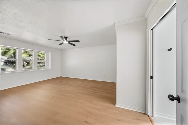 an empty room with windows and closet