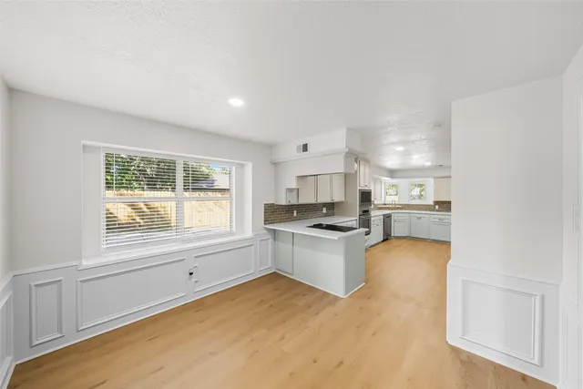 a kitchen with a refrigerator and a stove top oven