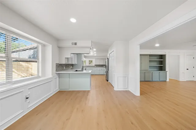 a view of a kitchen with a sink dishwasher and a refrigerator