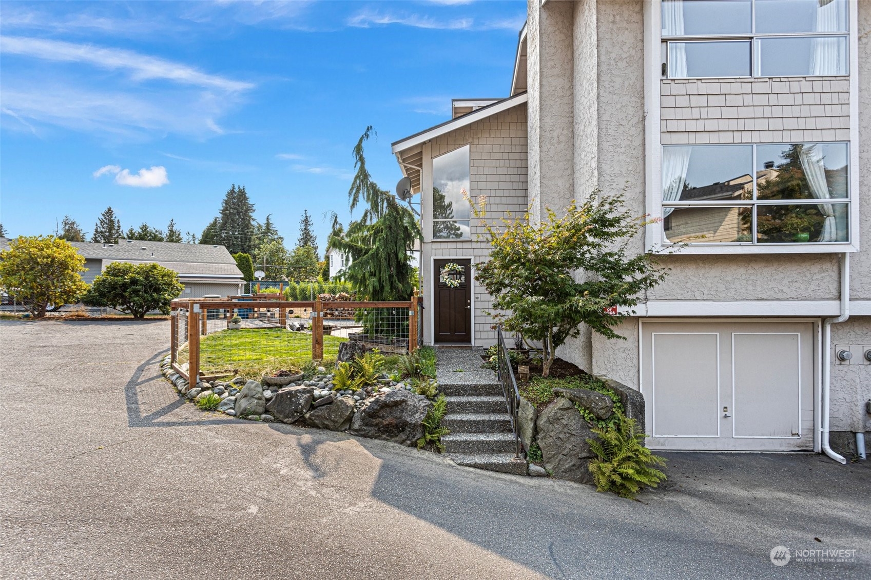 9110 Park Road, Unit 300L Edmonds, WA 98026 - Photo 1 of 27 a front view of a house with garden