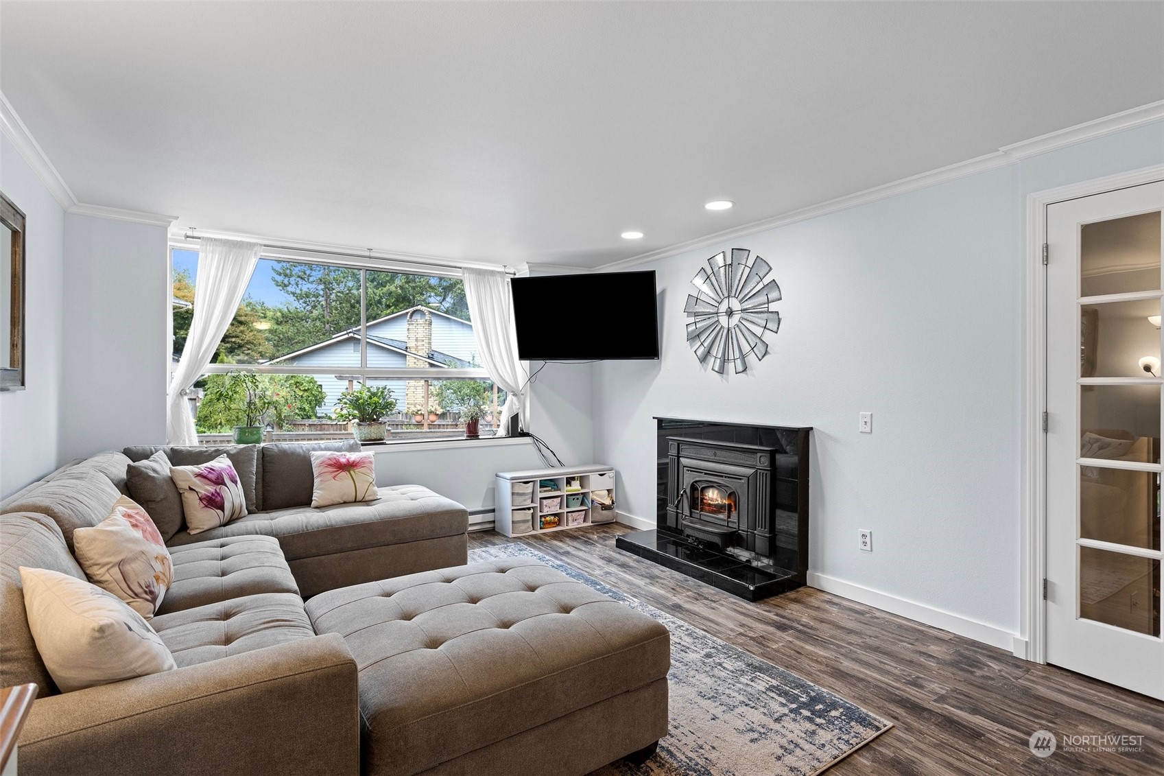 9110 Park Road, Unit 300L Edmonds, WA 98026 - Photo 6 of 27 a living room with furniture a fireplace and a flat screen tv