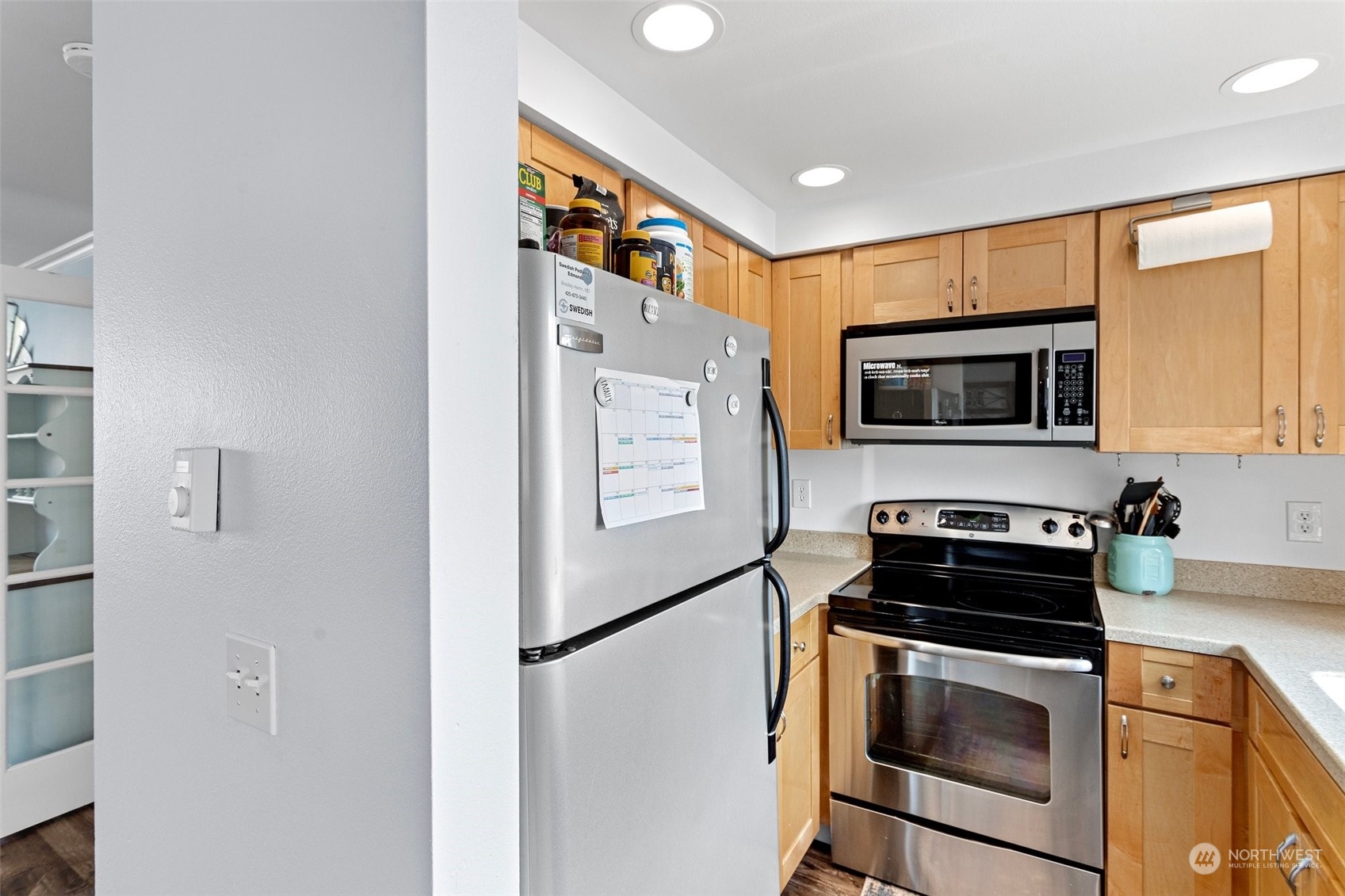 9110 Park Road, Unit 300L Edmonds, WA 98026 - Photo 7 of 27 a kitchen with stainless steel appliances a stove a microwave and a refrigerator