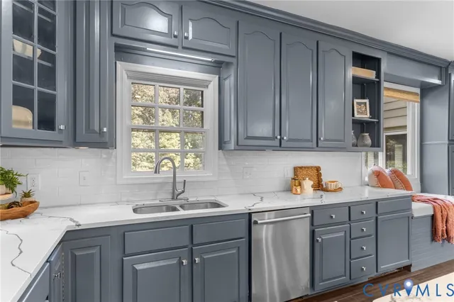 a kitchen with stainless steel appliances granite countertop a sink a cabinets and window