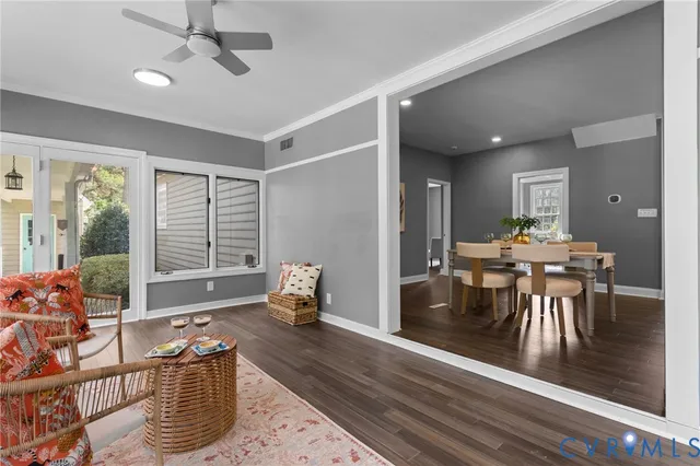 a living room with furniture and wooden floor