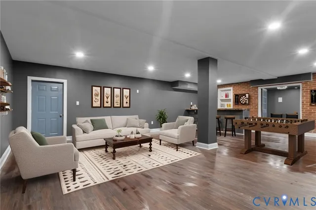 a living room with furniture and wooden floor