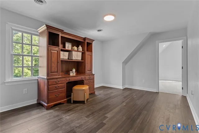 a view of room with window and wooden floor