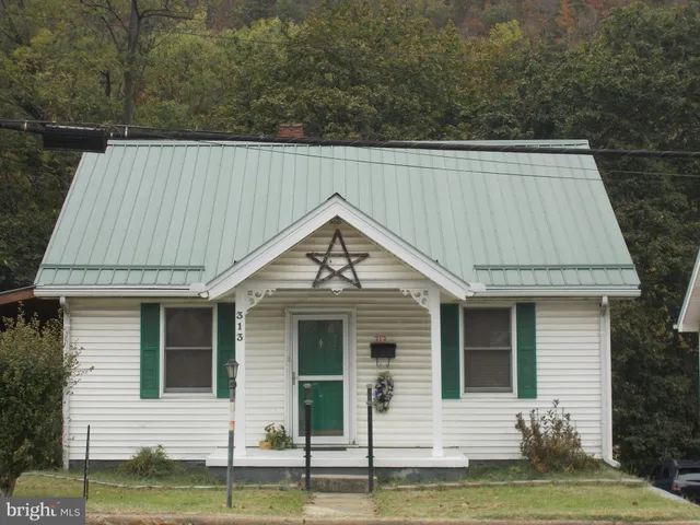 a front view of a house with a garden and yard
