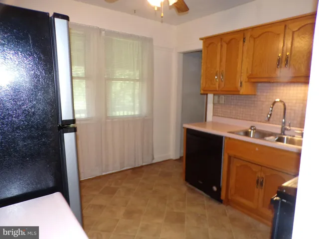 a kitchen with a sink cabinets and a window