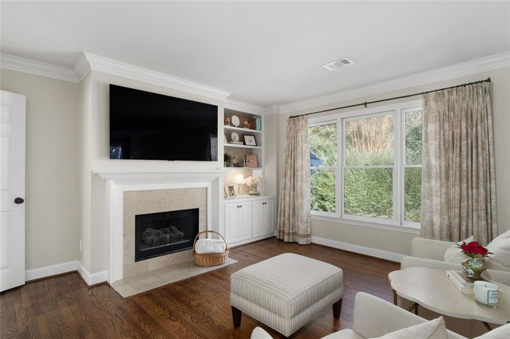 310 Glen Hampton Place Alpharetta, GA 30004 - Photo 16 of 61 a living room with furniture a flat screen tv and a fireplace