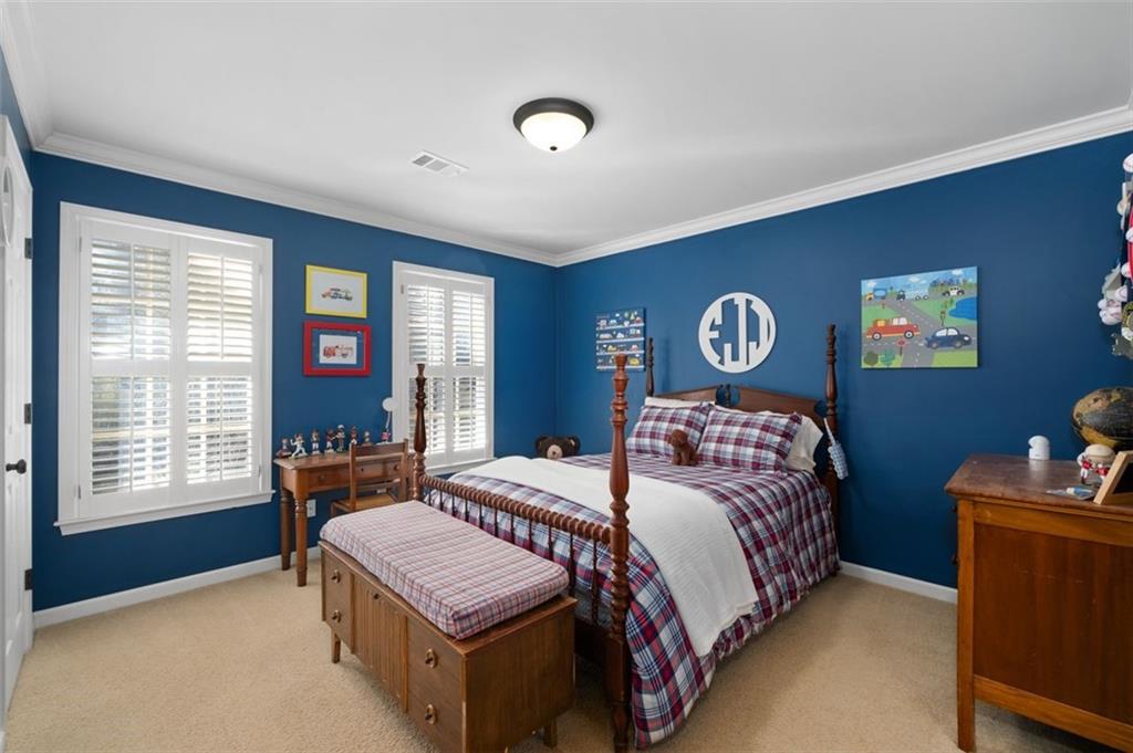 310 Glen Hampton Place Alpharetta, GA 30004 - Photo 22 of 61 a bedroom with a bed and a table in it with windows