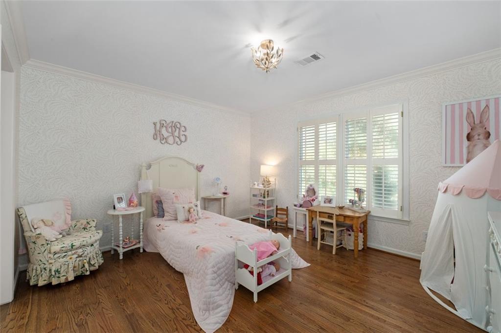 310 Glen Hampton Place Alpharetta, GA 30004 - Photo 25 of 61 a spacious bedroom with a bed and wooden floor