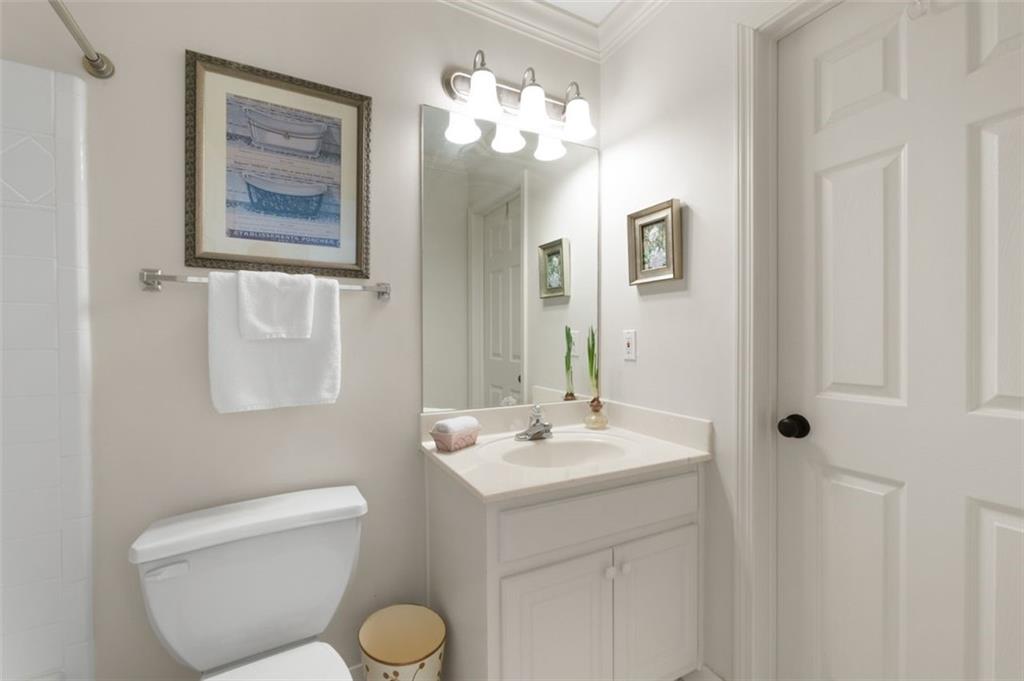 310 Glen Hampton Place Alpharetta, GA 30004 - Photo 27 of 61 a bathroom with a toilet sink and mirror