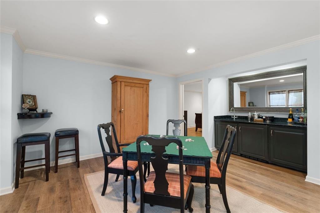 310 Glen Hampton Place Alpharetta, GA 30004 - Photo 30 of 61 a view of a dining room with furniture and wooden floor