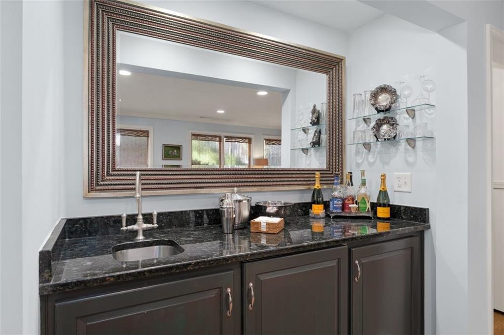 310 Glen Hampton Place Alpharetta, GA 30004 - Photo 31 of 61 a kitchen with granite countertop a sink and cabinets