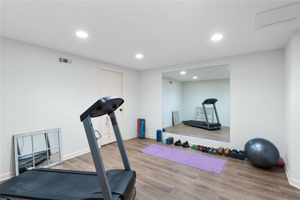 310 Glen Hampton Place Alpharetta, GA 30004 - Photo 34 of 61 a room with furniture and a wooden floor