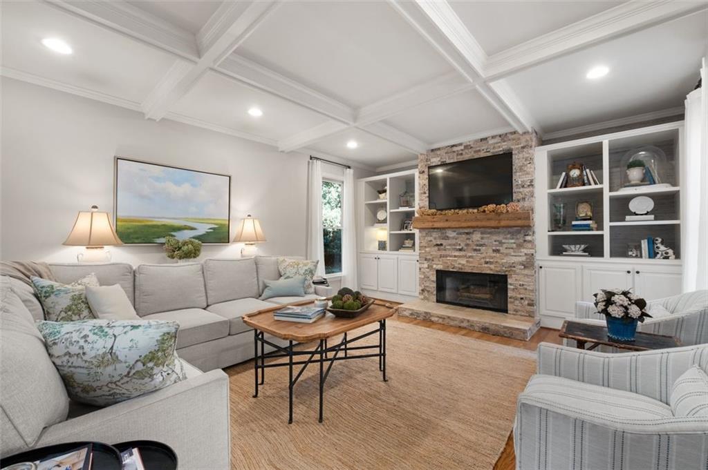 310 Glen Hampton Place Alpharetta, GA 30004 - Photo 4 of 61 a living room with furniture a fireplace and a flat screen tv