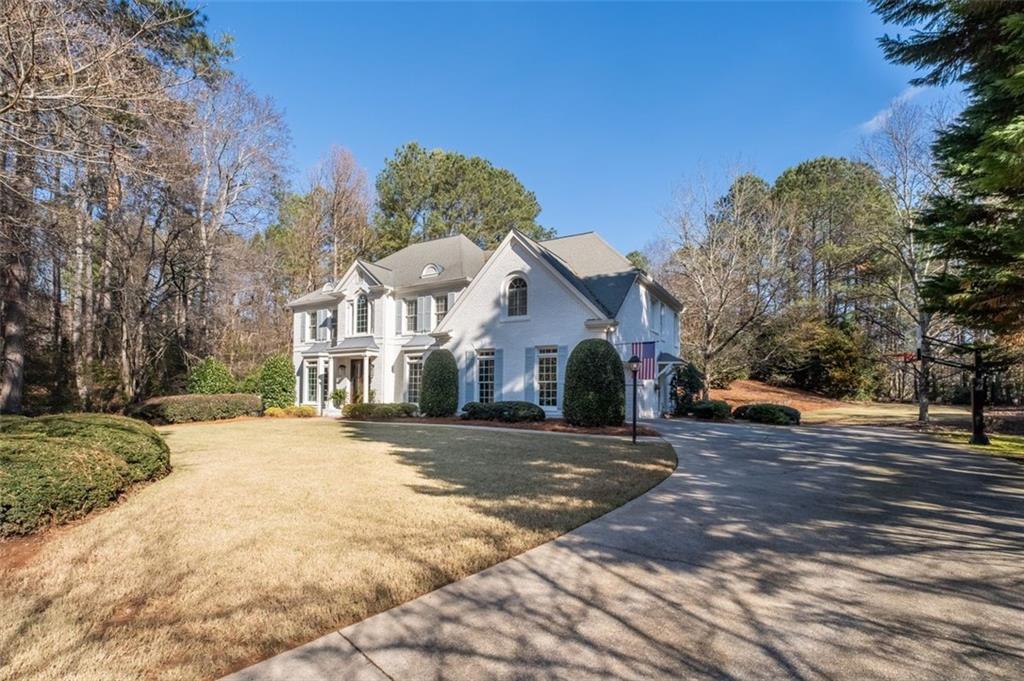 310 Glen Hampton Place Alpharetta, GA 30004 - Photo 44 of 61 a front view of a house with a yard